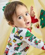 Child looking over one shoulder in the Merry Truckmas Bamboo Zippy, showing Christmas trees and construction vehicles across the sleeve and back.
