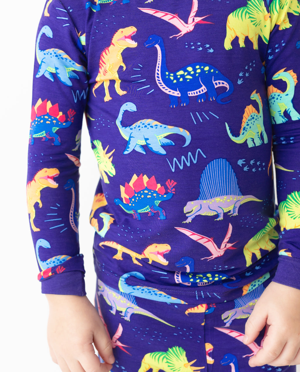 Close view of colorful dinosaur print on Neo Dino pajamas
