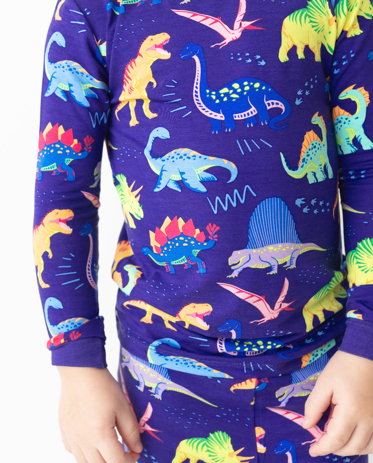 Close view of colorful dinosaur print on Neo Dino pajamas