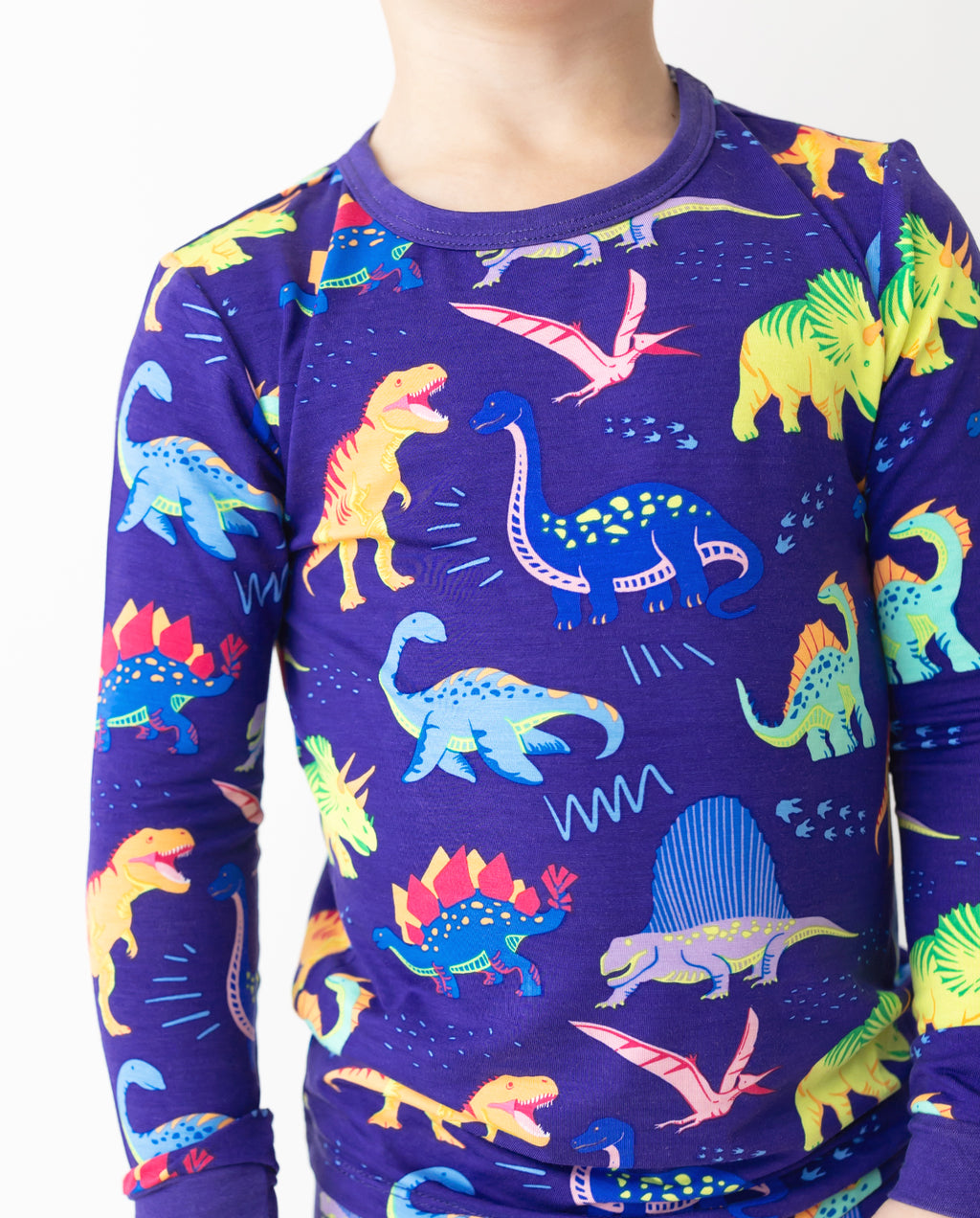 Close view of the neckline and dinosaur print on Neo Dino pajamas