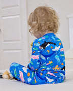 Back view of a child seated in blue Ocean Friends pajamas
