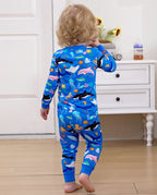 Back view of a child standing in blue sea-creature pajamas