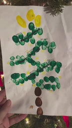 A handmade Christmas tree artwork transformed into matching babee Reshinee Createe Cozee custom pajamas for children