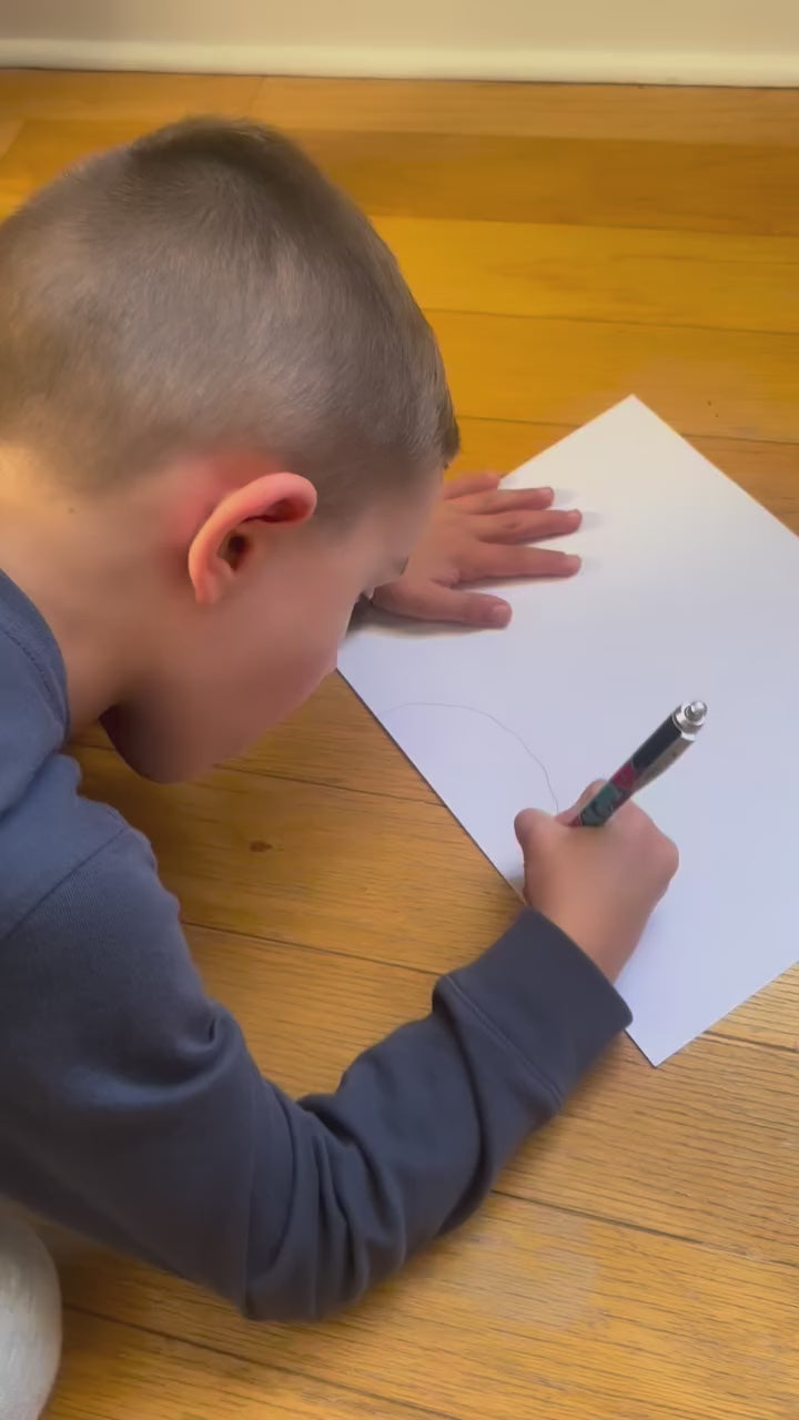 Child creating original artwork that becomes matching babee Reshinee Createe Cozee custom pajamas