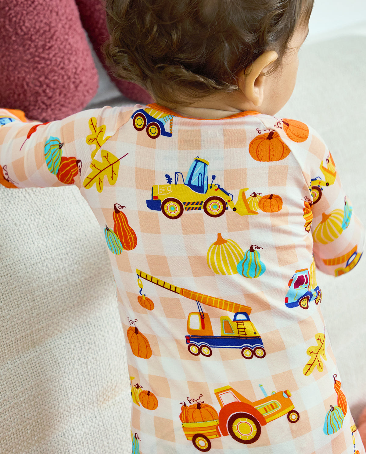 Back detail of Pumpkin Tractors Bamboo Zippy showing construction vehicles and pumpkins on a cream check background.