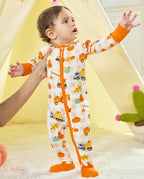 Front view of a baby standing in Pumpkin Tractors Bamboo Zippy with orange cuffs and a two-way zipper.
