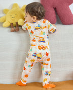 Full back view of Pumpkin Tractors Bamboo Zippy on a baby standing beside a sofa.