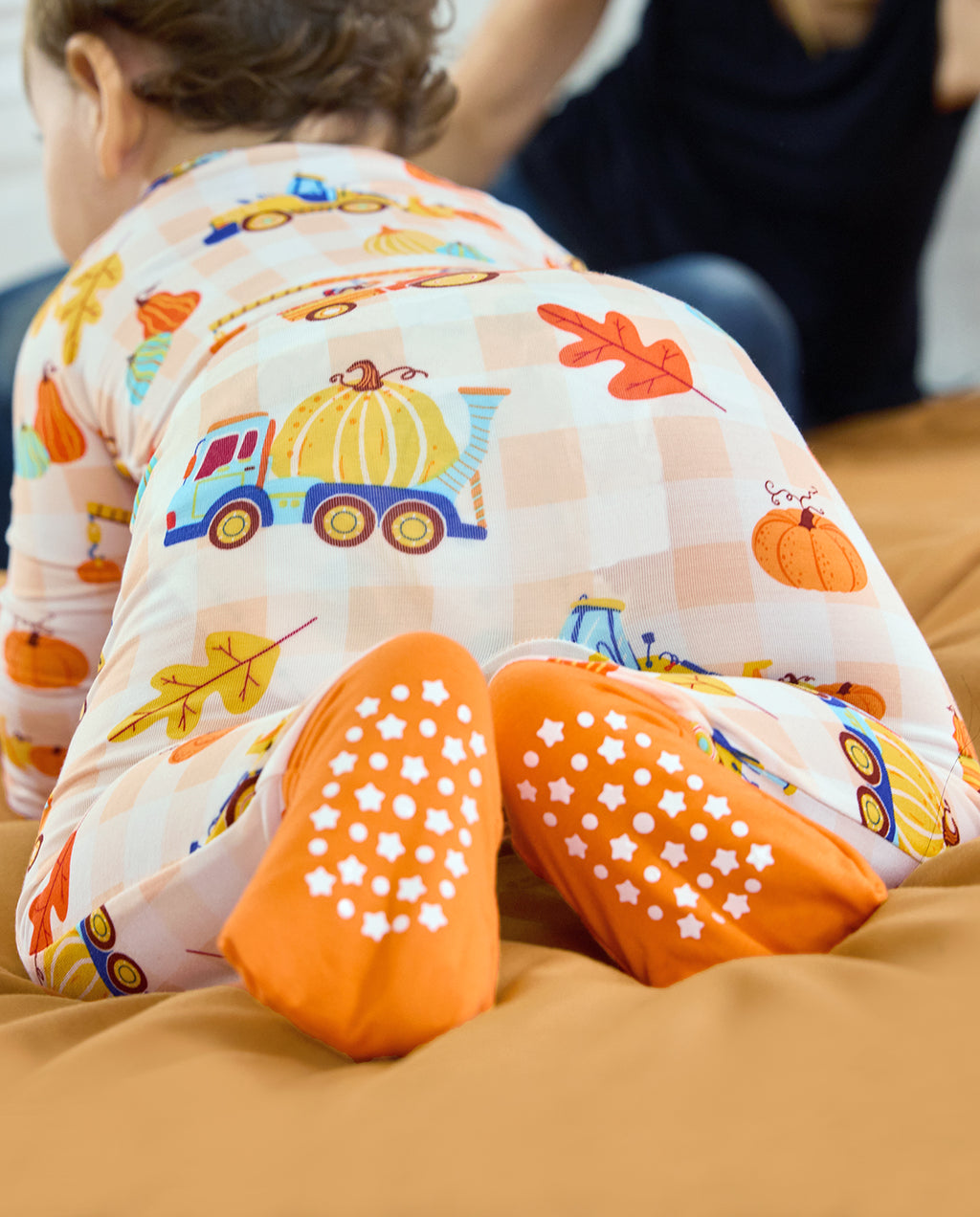 Pumpkin Tractors Bamboo Zippy showing orange foot cuffs with white grip dots.