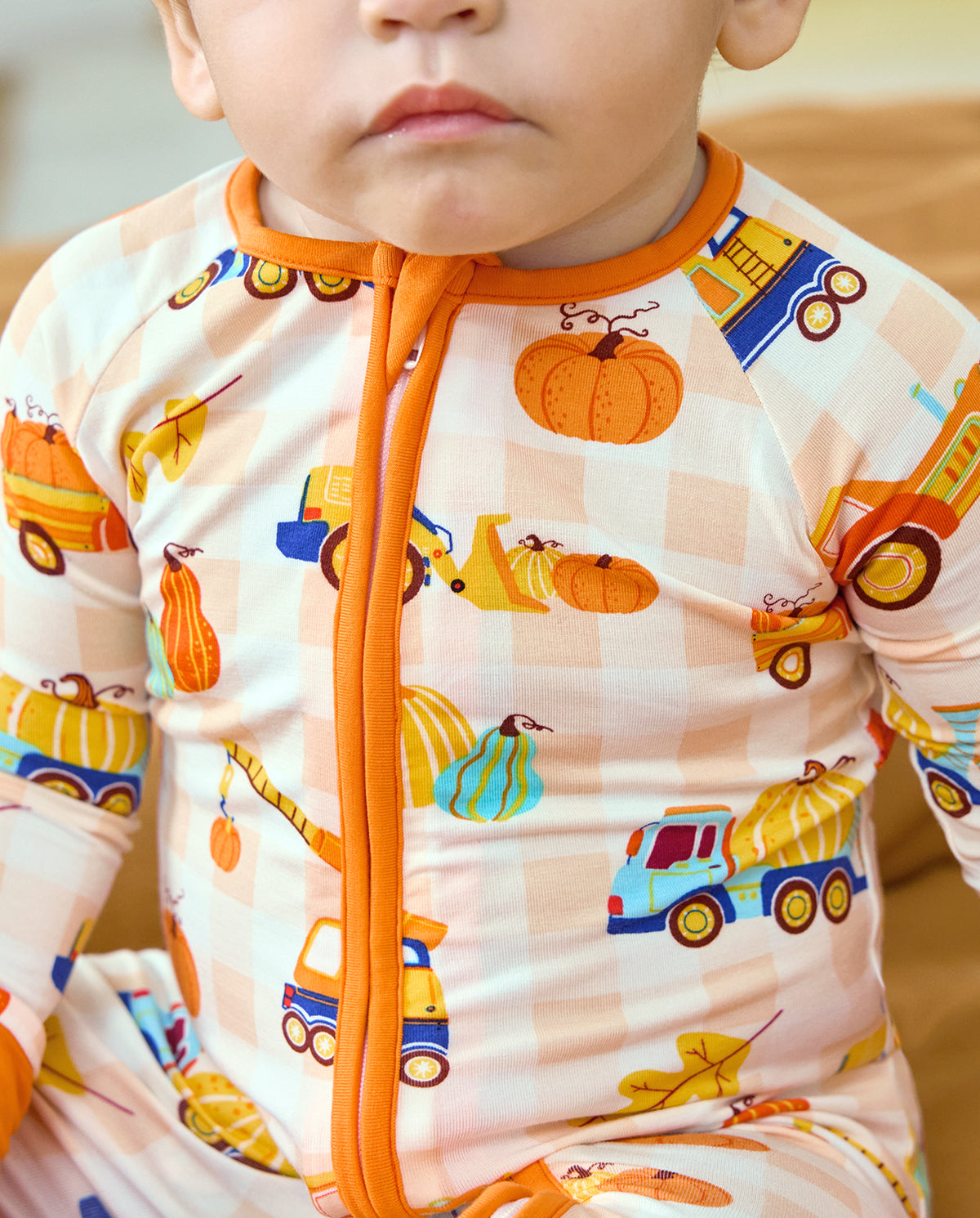 Close-up of the orange neckline and zipper on Pumpkin Tractors Bamboo Zippy.