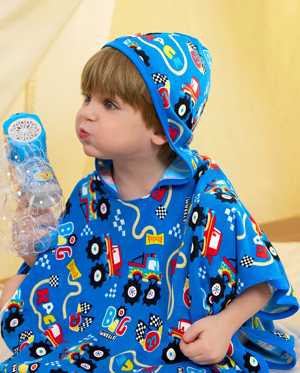 Ready? Go! Hooded Toddler Bath Towel - child wearing the hooded towel while holding a bubble toy