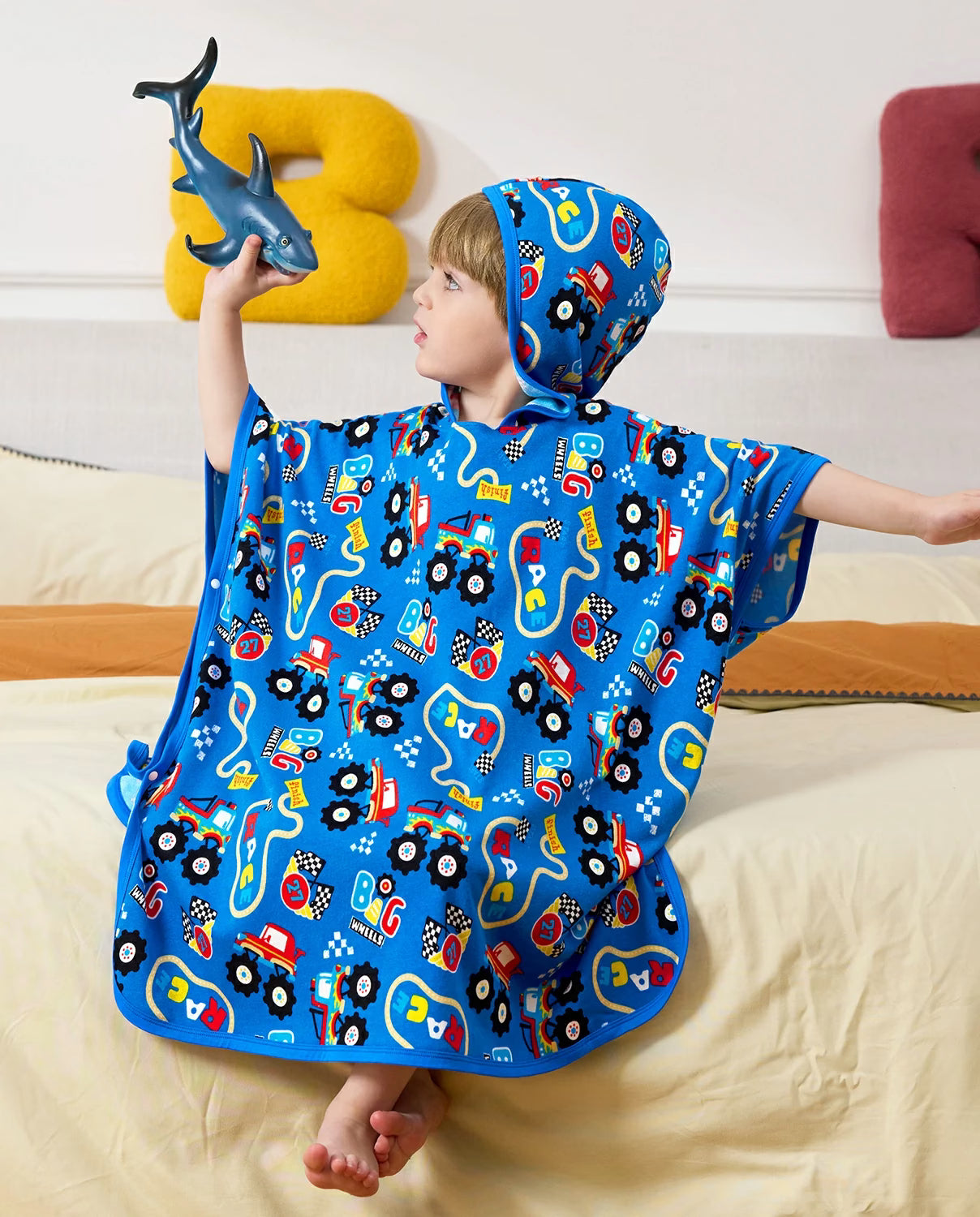 Ready? Go! Hooded Toddler Bath Towel - child wearing the hooded towel while playing with a toy shark