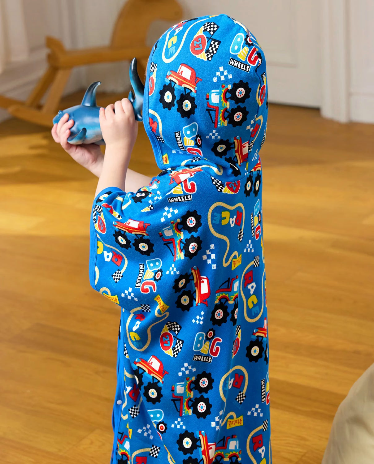 Ready? Go! Hooded Toddler Bath Towel - child wearing the hooded towel while holding a toy, side view