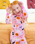 Spooky Cute Long Two-Piece Pajama Set - child wearing the pajamas while adjusting orange glasses