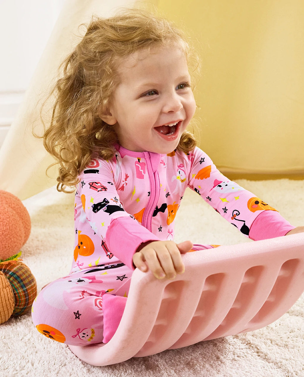 Spooky Cute Bamboo Zippy baby pajamas with Halloween ghosts and pumpkin print during playtime