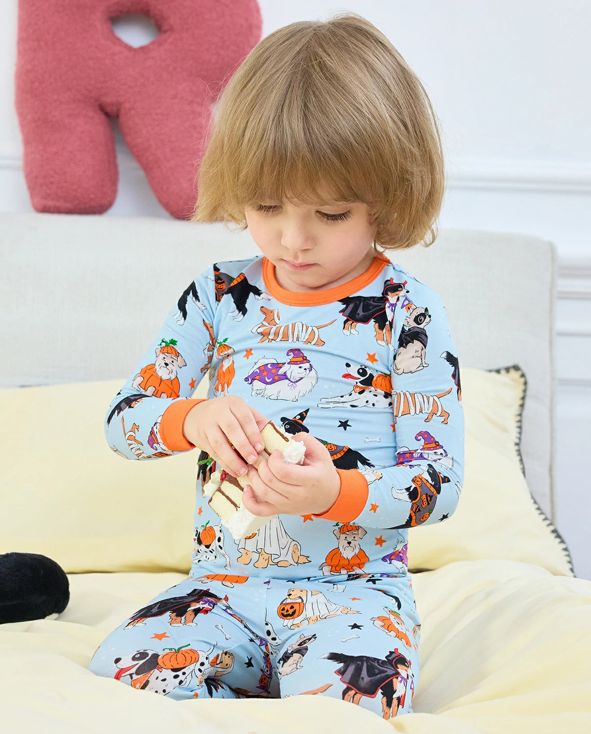 Spooky Pups Long Two-Piece Pajama Set - child wearing the pajamas while seated and playing