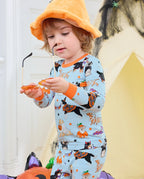 Spooky Pups Long Two-Piece Pajama Set - child wearing the pajamas with an orange witch hat