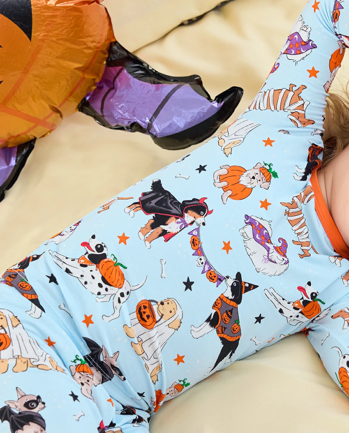 Spooky Pups Long Two-Piece Pajama Set - close-up of the puppy print while the child is seated