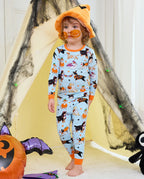 Spooky Pups Long Two-Piece Pajama Set - child wearing the pajamas and an orange witch hat, front view
