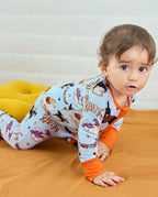 Baby crawling in Spooky Pups Bamboo Zippy on wooden floor
