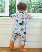 Back view of baby wearing Spooky Pups Bamboo Zippy by window