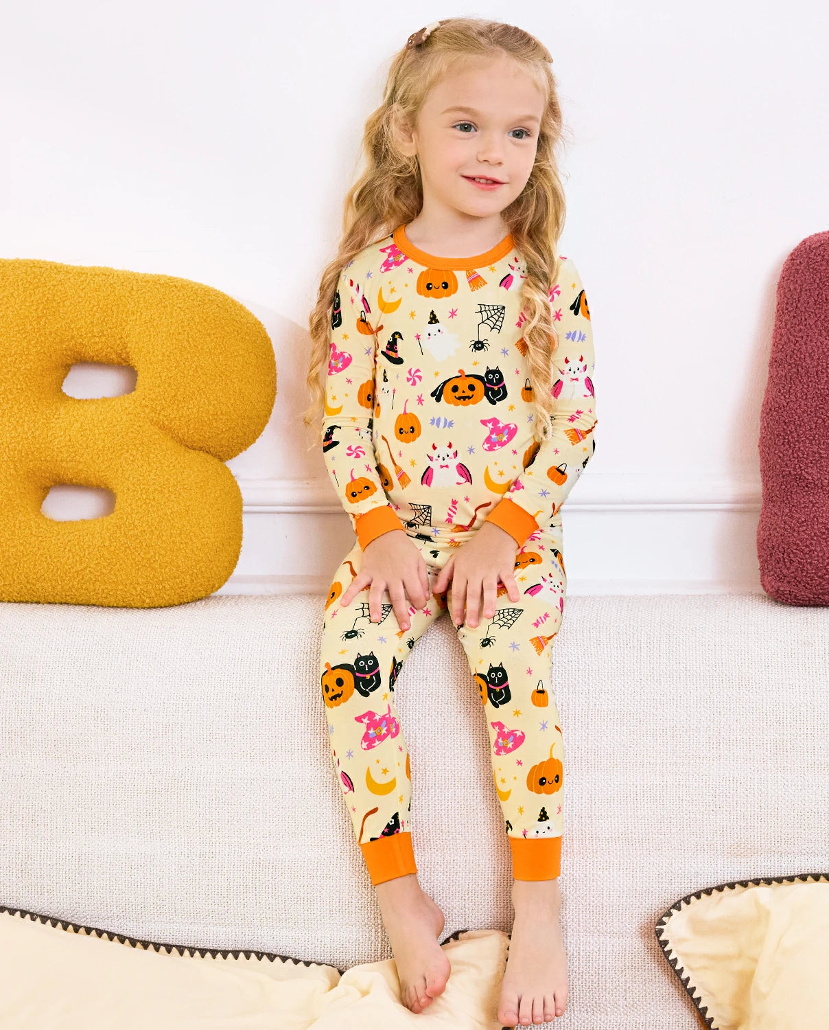 Spooky Sweet Long Two-Piece Pajama Set - child wearing the pajamas while standing, full front view