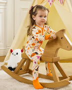 Baby wearing Spooky Sweet Bamboo Zippy during indoor playtime