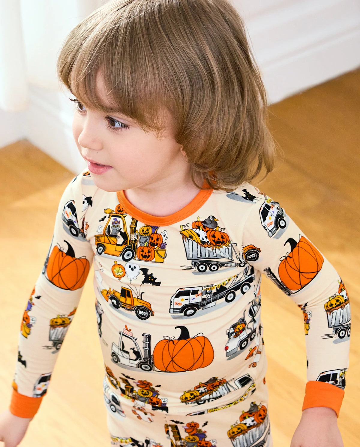 Trick Trucks Long Two-Piece Pajama Set - child wearing the pajamas while standing, three-quarter view