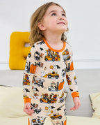 Trick Trucks Long Two-Piece Pajama Set - child wearing the pajamas and looking upward, upper-body view