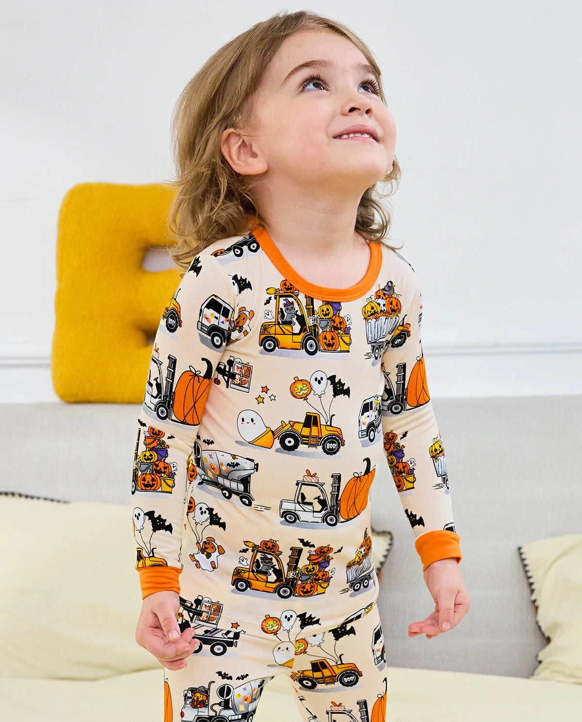 Trick Trucks Long Two-Piece Pajama Set - child wearing the pajamas and looking upward, upper-body view
