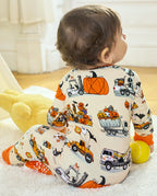 Baby sitting in Trick Trucks bamboo zippy with Halloween truck and pumpkin print