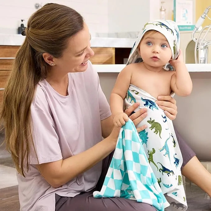 Parent wrapping a baby in soft Babee Reshinee fabric